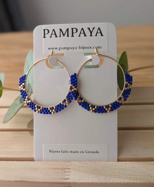 Créoles bleues et dorées en perles tissées à la main sur présentoir Pampaya bijoux