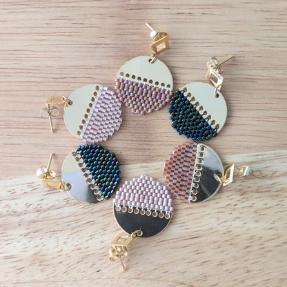 Boucles d'oreilles rondes tissées présentées en rond et déclinées en trois couleurs : rouge, beige rosé et bleu vert irisé.